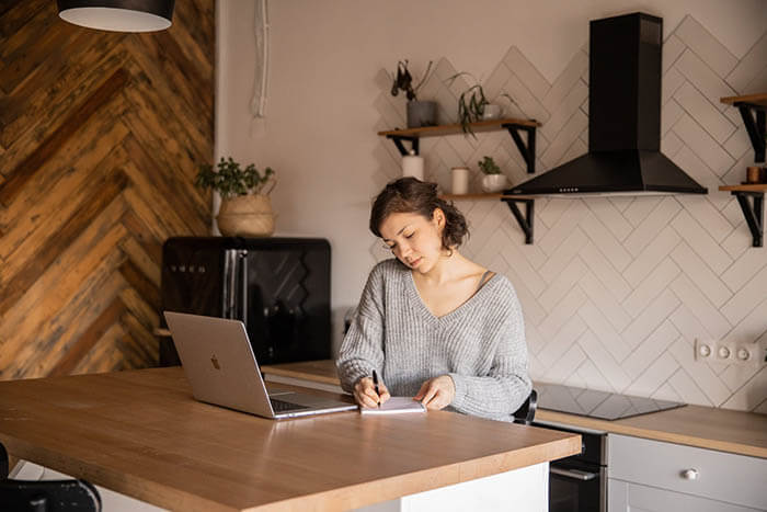 woman writing on wooden desk banner