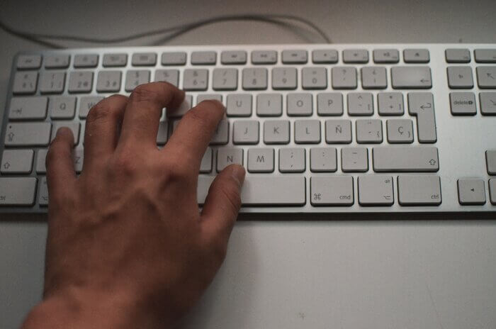 left hand on white keyboard