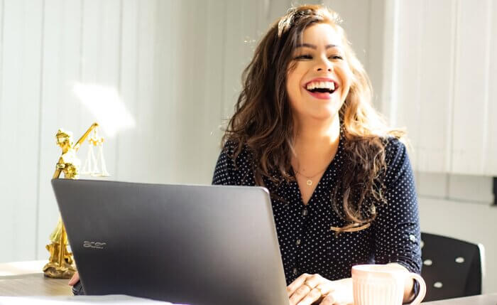 woman at laptop smiling