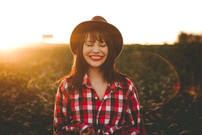 woman in red and white shirt smiling
