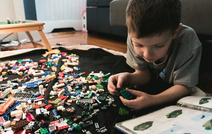 boy assembling lego